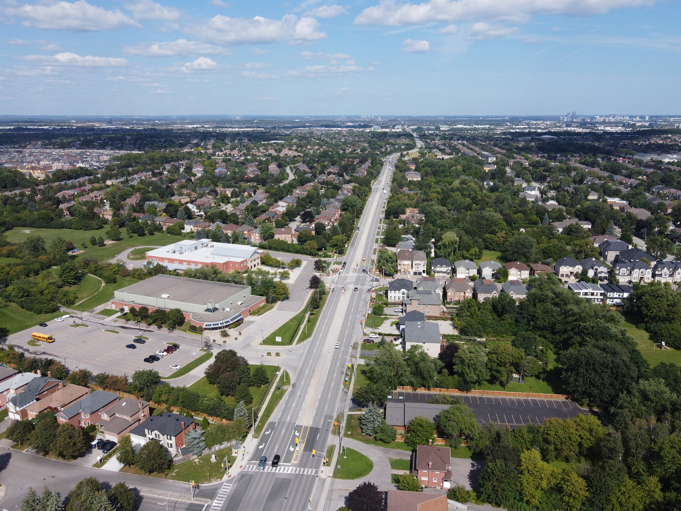 Aerial drone view over a residential neighbourhood in Ontario Canada showing rooftops and building infrastructure assessed from above